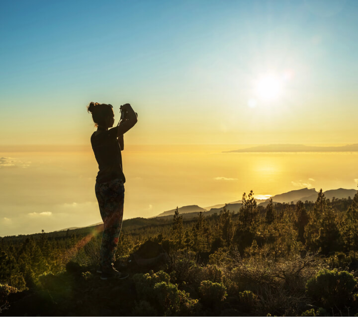 img - silhouette-woman-camera-woman-takes-photo-gomera-island-rays-setting